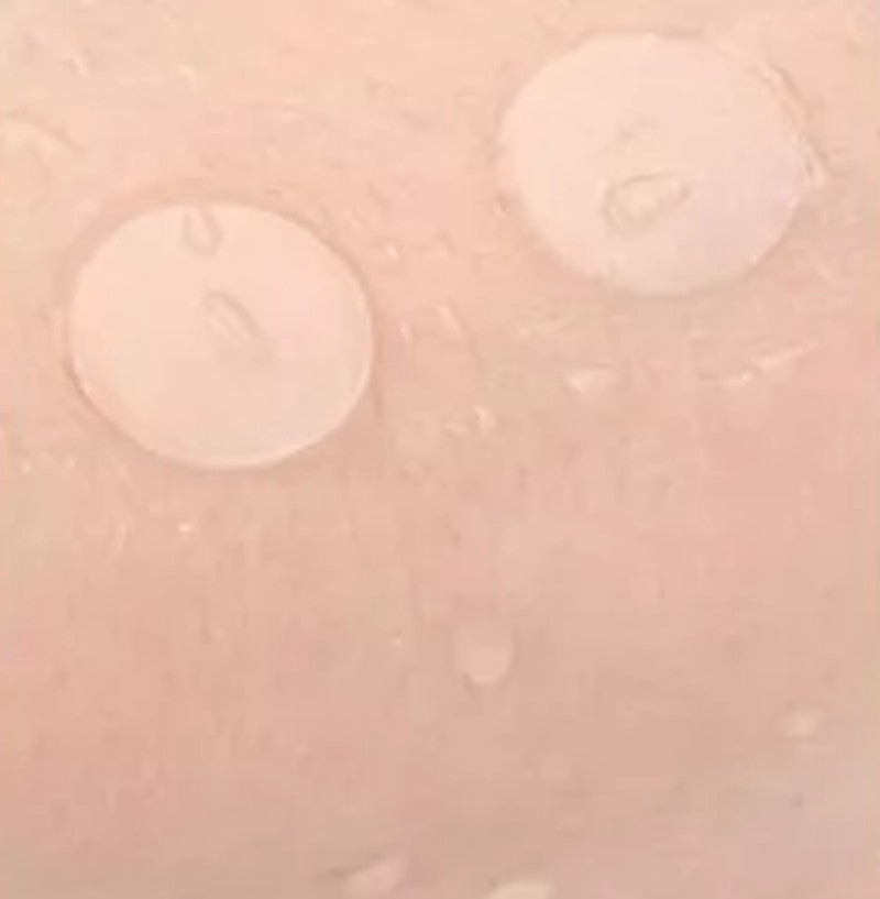 Two thin patches on wet skin showing they are waterproof